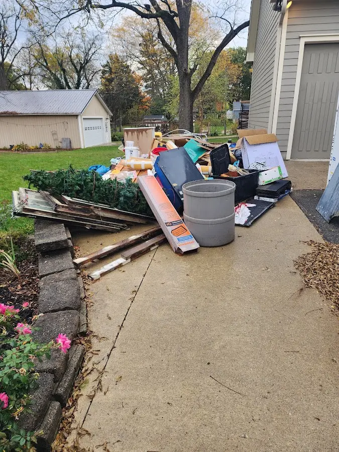Dumpster being loaded with debris for 12 Yard Dumpster Rental in Alum Rock